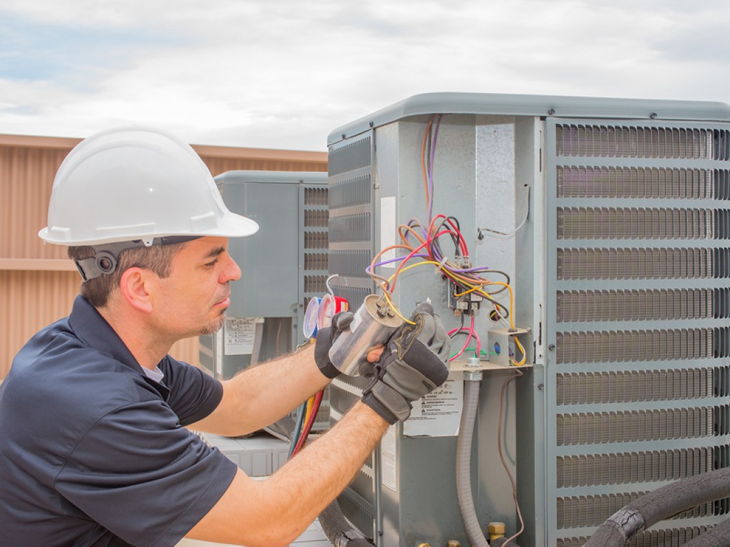 man installing an air conditioner unit