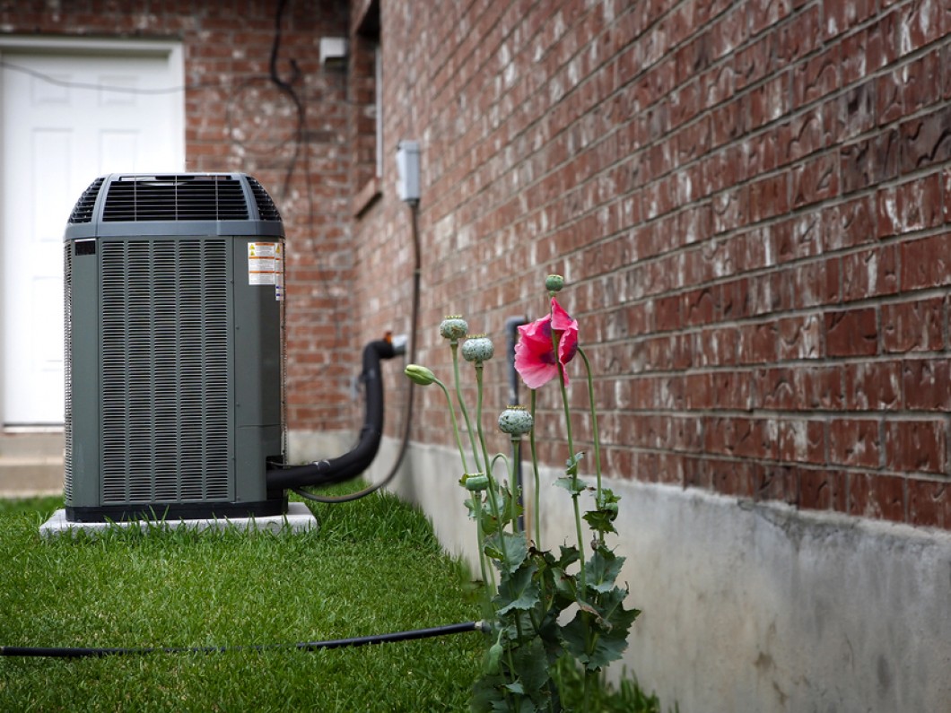 air conditioner unit attached to side of a house